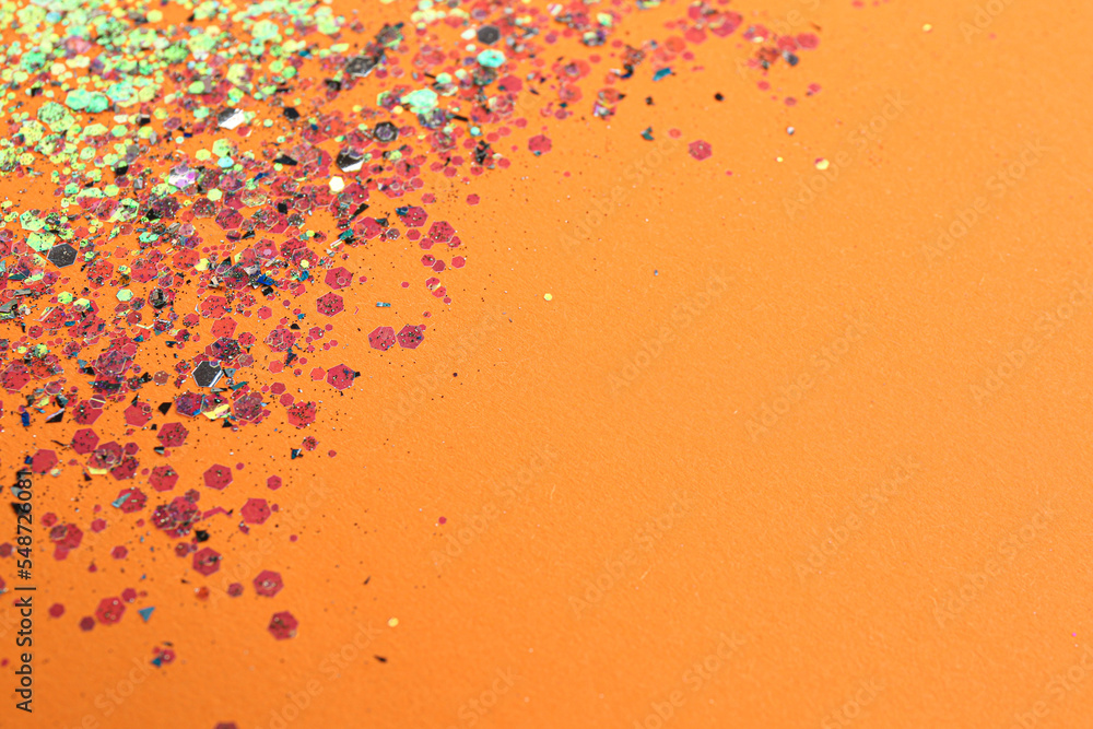 Shiny bright glitter on orange background. Space for text Shiny bright glitter on orange background. Space for text