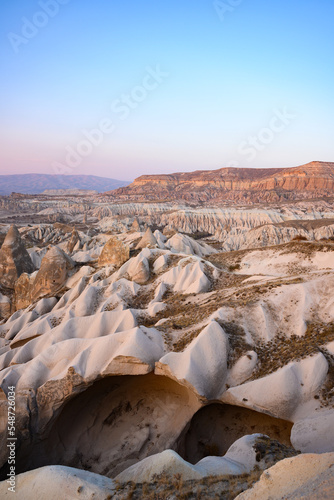 Stunning view of some rock formations in the Red & Rose Valley in Cappadocia during a beautiful sunset. Goreme, central Antolia, Turkey.