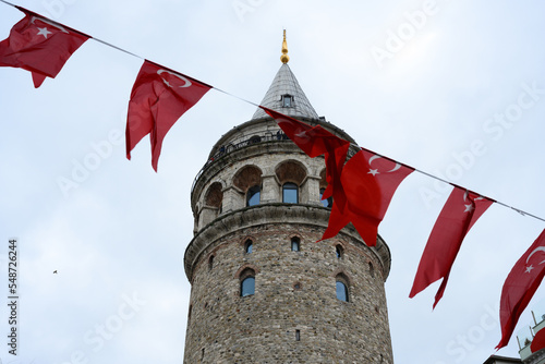 Photography (Selective focus, focus on the Tower) Blurred Turkish National Flags in the foreground with the Galata Tower in the background