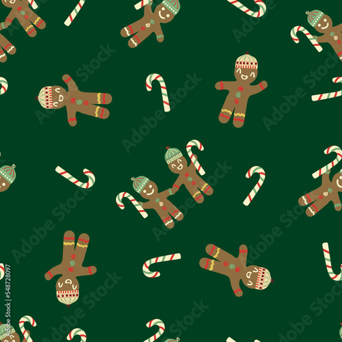 Cute gingerbread men wearing hats, candy canes vector pattern background.Traditional Christmas laughing cookie character motifs and sweet sticks green backdrop. Fun festive style for Holidays.