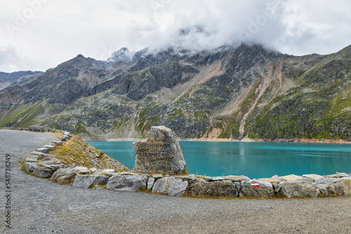 Finstertaler reservoir in Austrian Alps mountains with blue water and beautiful mountains all around it photo