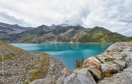 Finstertaler reservoir in Austrian Alps mountains with blue water and beautiful mountains all around it