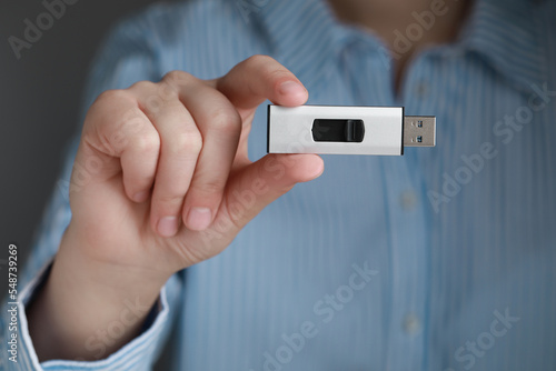 Vászonkép Woman holding usb flash drive, closeup view