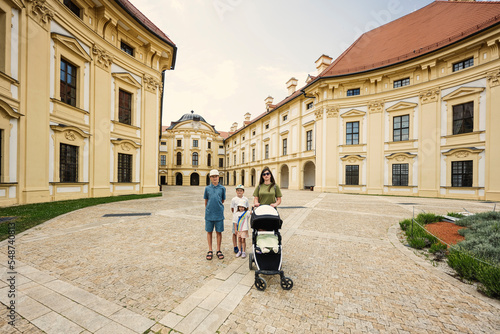 Mother with children at Slavkov Castle, also known as Austerlitz Castle, is a Baroque palace in Slavkov u Brna, Czech Republic