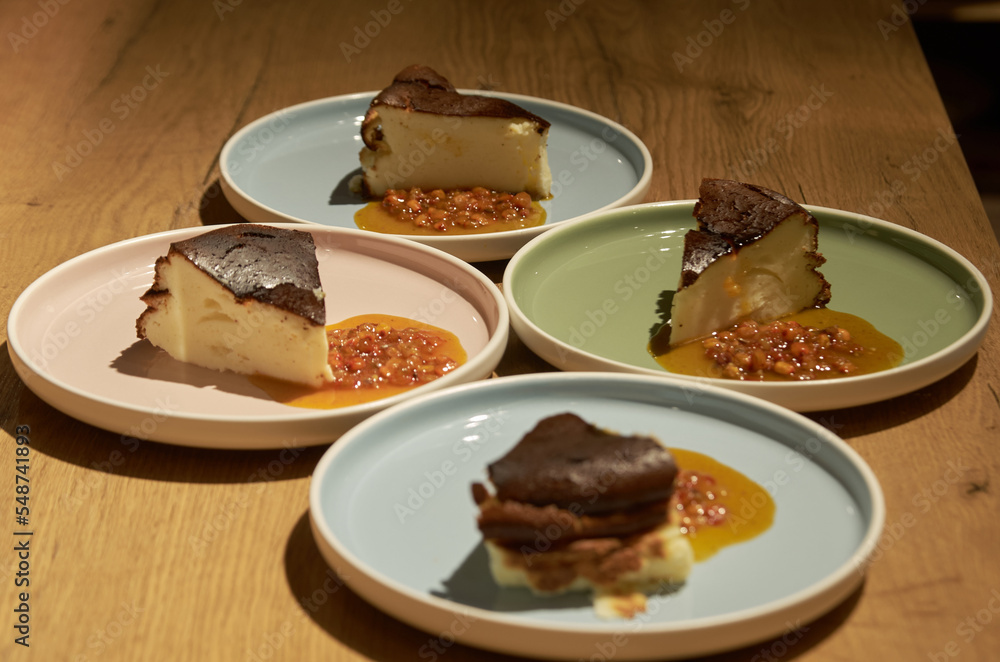 Piece of cheesecake with sea buckthorn jam on a plate Piece of cheesecake with sea buckthorn jam on a plate
