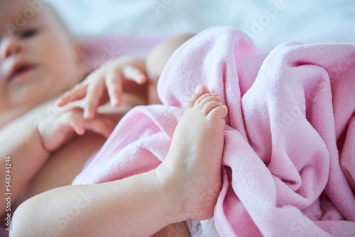 A small newborn baby girl. The concept of childhood and motherhood.