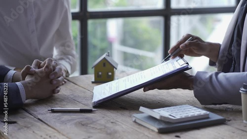 Real estate agent showing house with introduction document with house key, home insurance concept, family insurance, rent sale 4k video