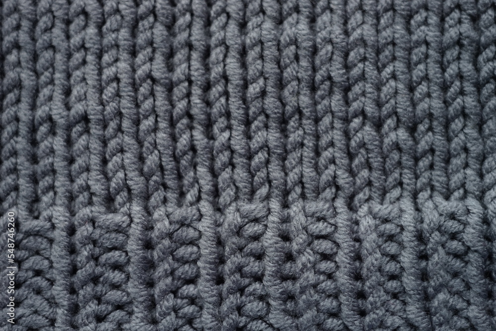 Knitted grey background, gray sweater cozy pattern Knitted grey background, gray sweater cozy pattern