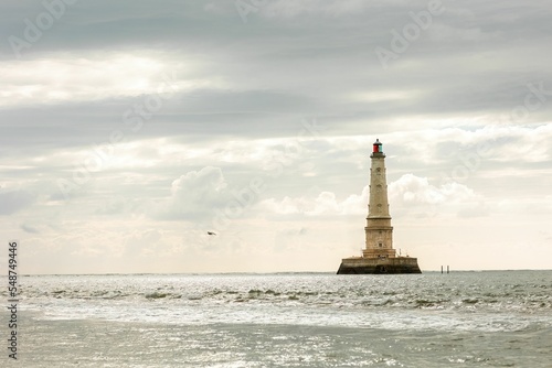 Beautiful view of the Cordouan Lighthouse under a cloudy sky in Le Verdon-sur-Mer, France. photo