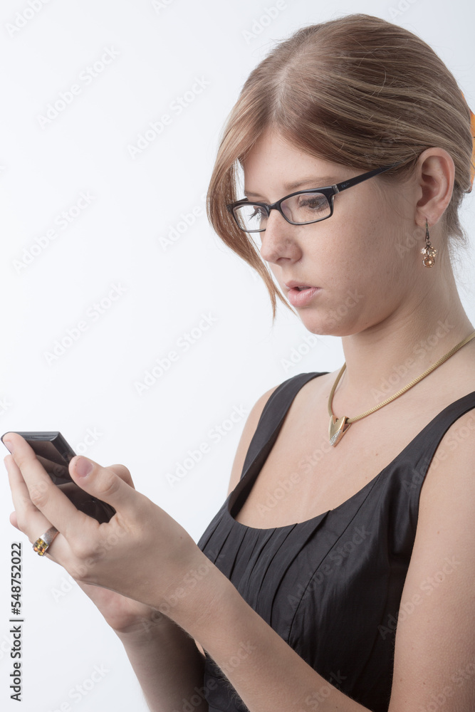 Young worried woman with a calculator in front a bright white background Young worried woman with a calculator in front a bright white background