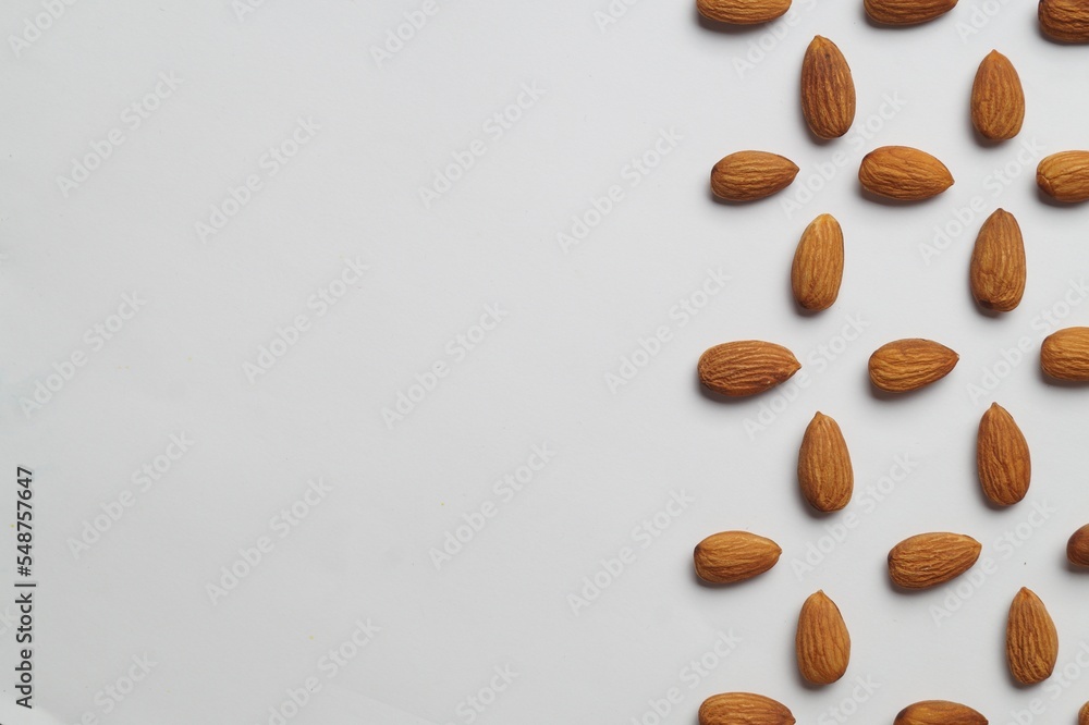 Delicious almonds on white background, flat lay. Space for text Delicious almonds on white background, flat lay. Space for text