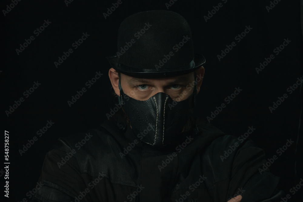 Scary figure with creepy mask and hat in the dark Scary figure with creepy mask and hat in the dark