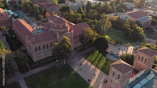 Aerial view orbiting UCLA Dickinson court pristine university campus at sunset photo