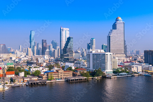 Modern Skyscraper of business center district at Bangkok skyline with blue sky background, Bangkok city is modern metropolis and favorite of tourists of Thailand © lukyeee_nuttawut