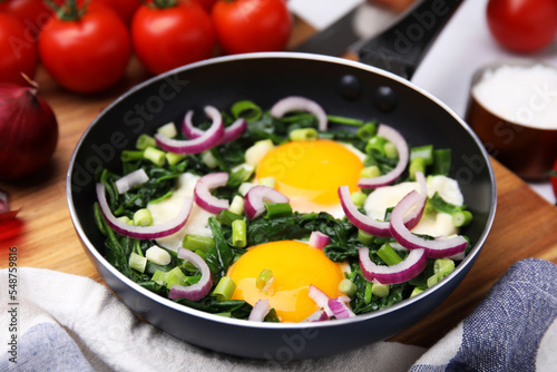 Tasty green Shakshouka served on table, closeup