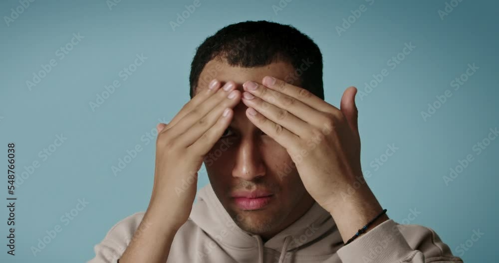 Positive man applying face cream. Closeup of male model with fresh skin applying Positive man applying face cream. Closeup of male model with fresh skin applying