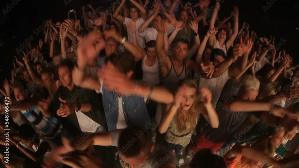 Concert audience, jump and clapping at music event together for live performance, outdoor festival and party celebration. Dancing at techno club, edm dance entertainment and fun crowd in nightclub