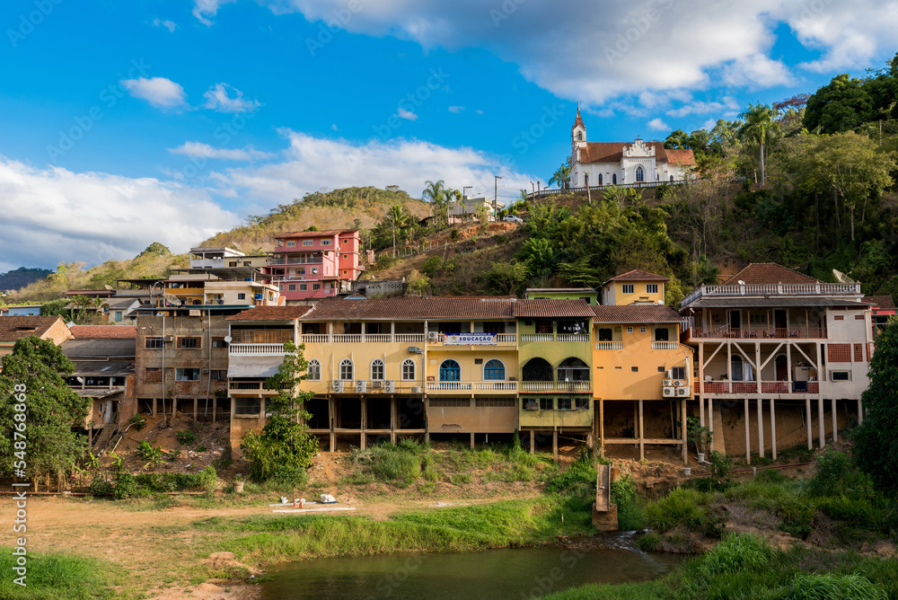 View of Houses in Front of a River and a Church on the Hill in Santa Leopoldina Town in Brazil