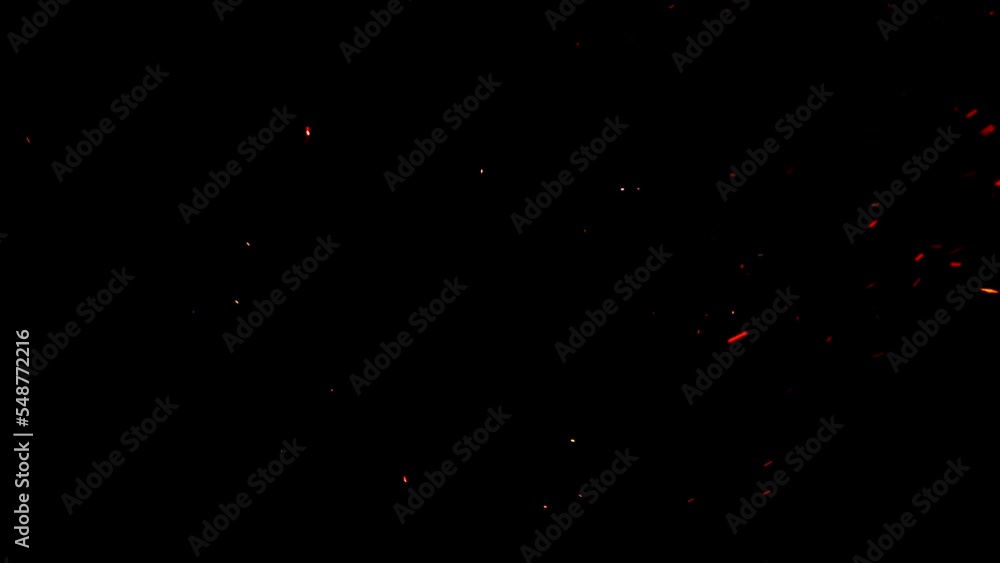 Soft hot ember particles on black ideal for overlays. The glowing embers float gently in the night air