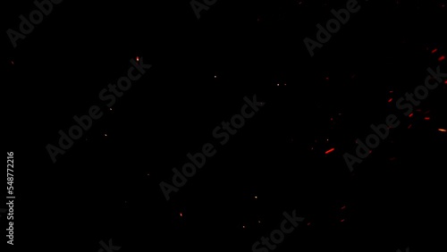 Soft hot ember particles on black ideal for overlays. The glowing embers float gently in the night air