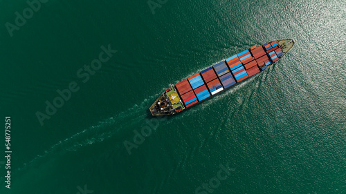 cargo container ship sailing in sea to import export goods and distributing products to dealer and consumers across worldwide, by container ship Transport business service.4k video taerial view .