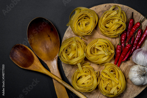 Pasta nests on a black background. traditional italian food
