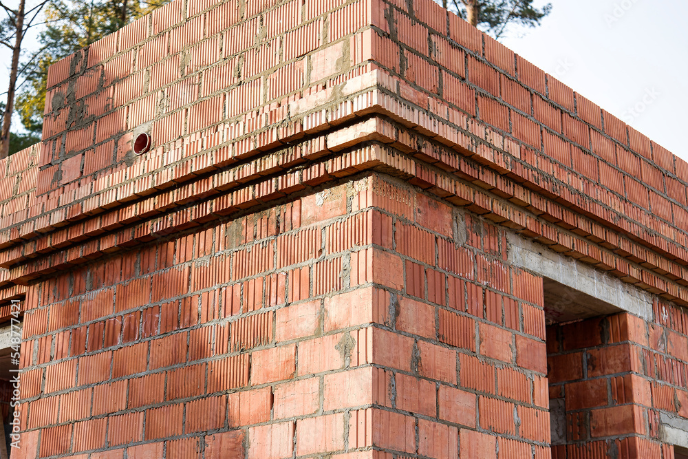 Construction of ceramic brick walls. Keramoblock. Hollow brick. Construction of a red brick house. Close-up. Material for the construction of walls and partitions.
