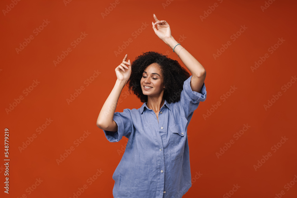 Young middle-eastern woman with curly hair smiling and dancing Young middle-eastern woman with curly hair smiling and dancing
