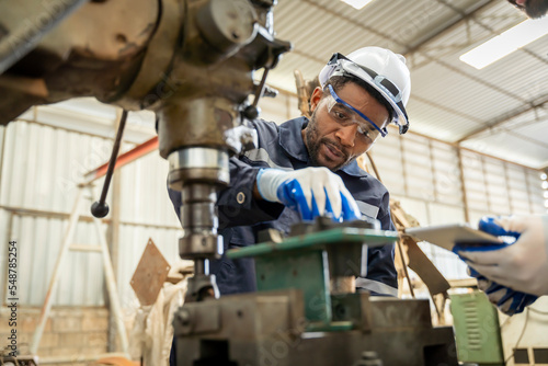 Team of engineers practicing maintenance Taking care and practicing maintenance of old machines in the factory so that they can be used continuously.