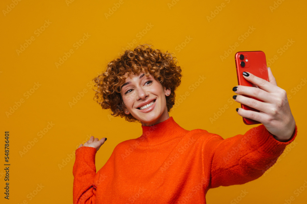 Middle-aged woman waving hand while while using mobile phone isolated Middle-aged woman waving hand while while using mobile phone isolated