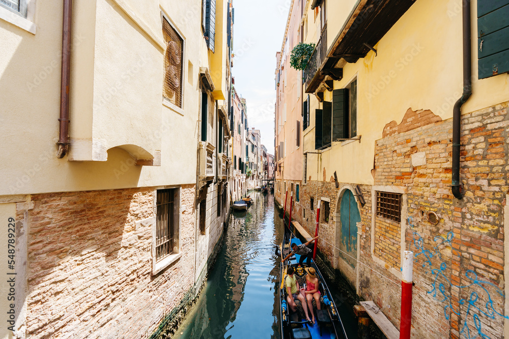 Gondola in a narrow Venetian canal