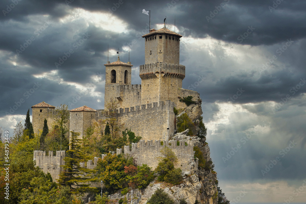 Castle on a rock in Republic of San Marino, HDR image with clouds in background Castle on a rock in Republic of San Marino, HDR image with clouds in background