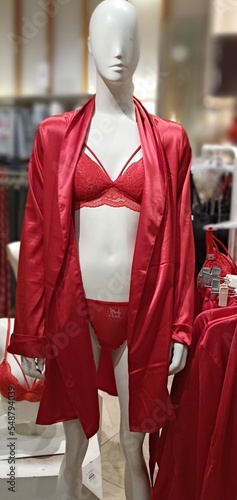 mannequin in women's red underwear and bathrobe