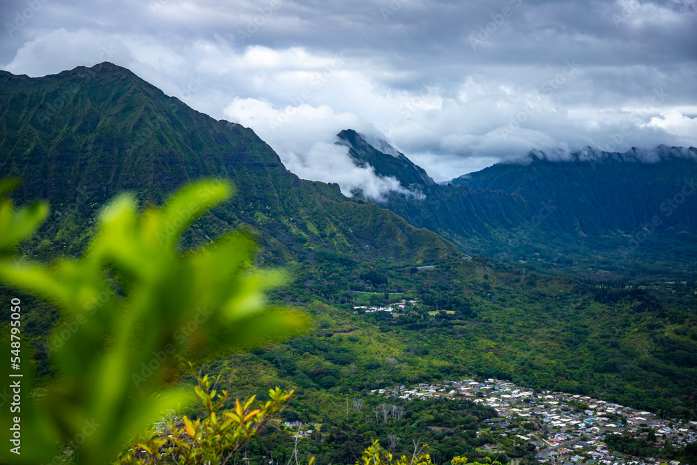 Fototapeta premium panorama of oahu and the hawaiian mountains as seen from the top of the olomana ridge trail; the famous three peaks on oahu, dangerous mountain hiking in hawaii, holidays in hawaii