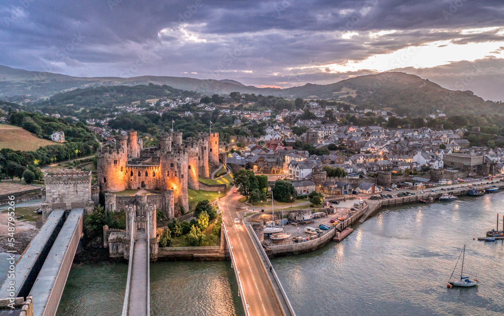Aerial view with Conwy town and the medieval castle, the famous landmark of Wales and UK, captured at sunset