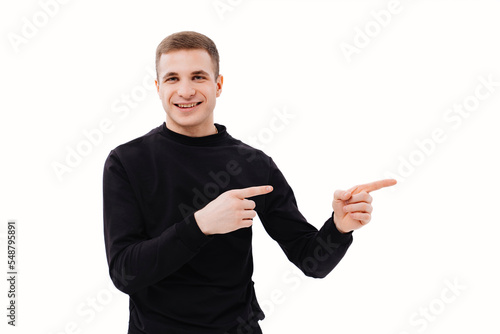a man in black clothes points his finger at something on a white background.