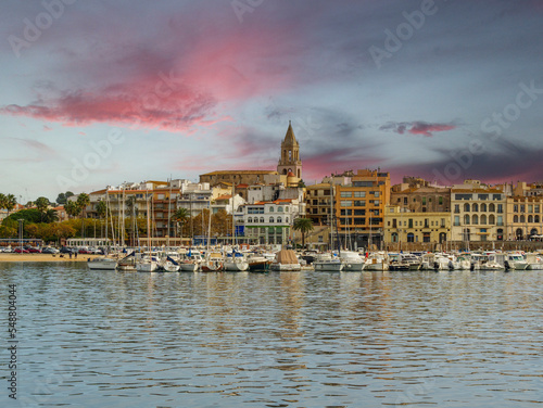 Beautiful seaside town of Palamós in Girona Costa Brava of Spain image of the city marina at sunset cathedral in the foreground tourism relaxation european