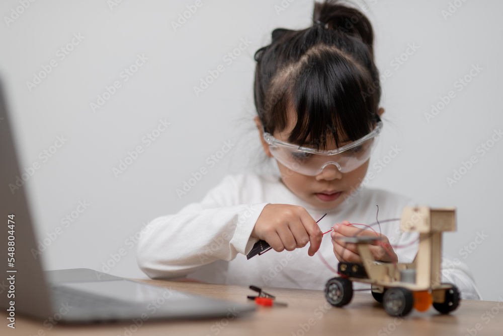 Asia students learn at home in coding robot cars and electronic board cables in STEM, STEAM, mathematics engineering science technology computer code in robotics for kids concept. Asia students learn at home in coding robot cars and electronic board cables in STEM, STEAM, mathematics engineering science technology computer code in robotics for kids concept.
