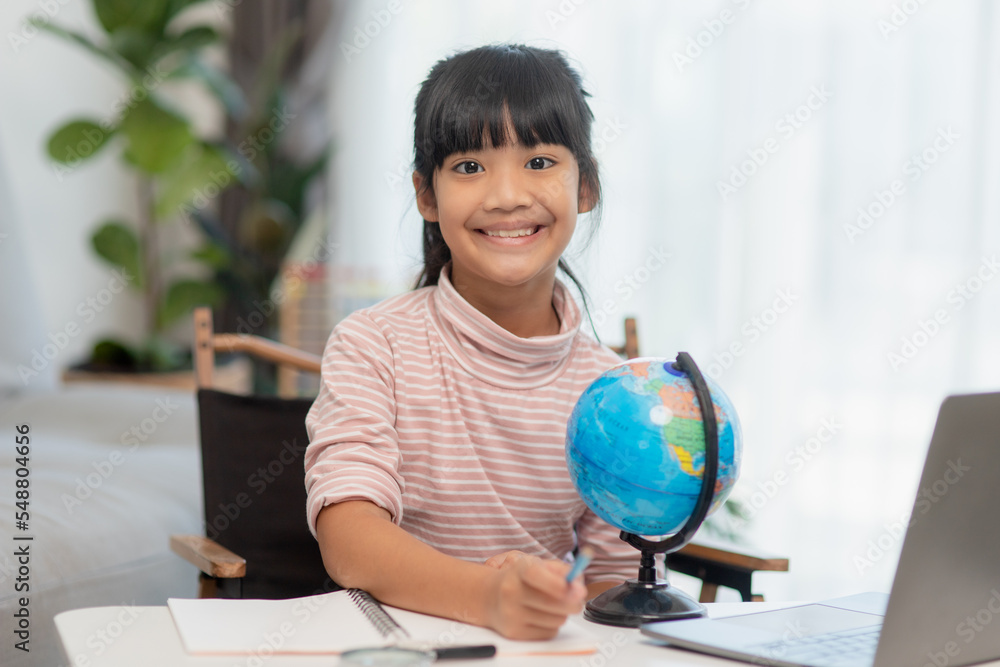 Asian little girl is learning the globe model, concept of save the world and learn through play activity for kid education at home. Asian little girl is learning the globe model, concept of save the world and learn through play activity for kid education at home.