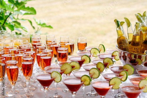 Photography Wedding garden party reception, family friends and guests enjoying a drink and cocktail in the background of the drinks table