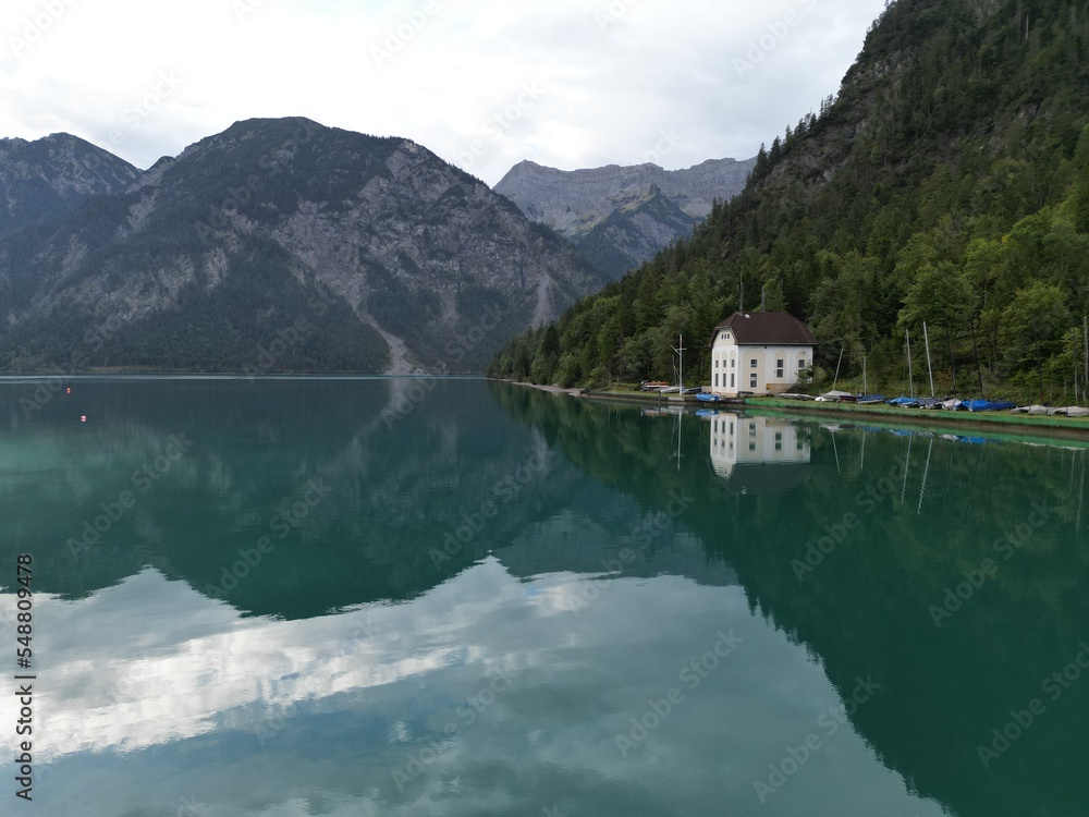 Lake in Tyrol Austria clear still water early morning drone aerial view