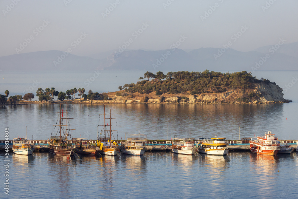 Boats at Marina on the Coast in a Touristic Town by the Aegean Sea. Kusadasi, Turkey. Sunny Morning Sunrise.