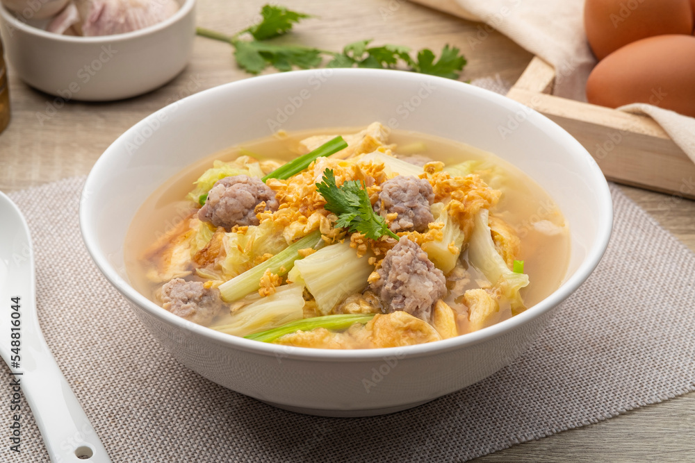 Clear soup with fried egg and minced pork ,Chinese Cabbage in white bowl Clear soup with fried egg and minced pork ,Chinese Cabbage in white bowl
