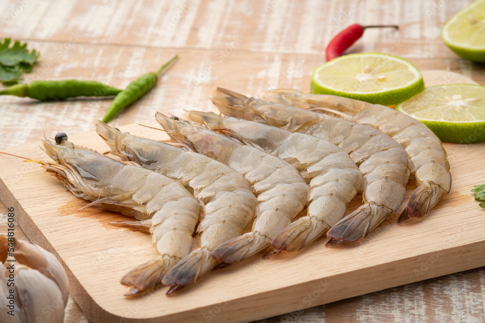 Close up Fresh raw shrimp (Litopenaeus vannamei) on wooden plate Close up Fresh raw shrimp (Litopenaeus vannamei) on wooden plate