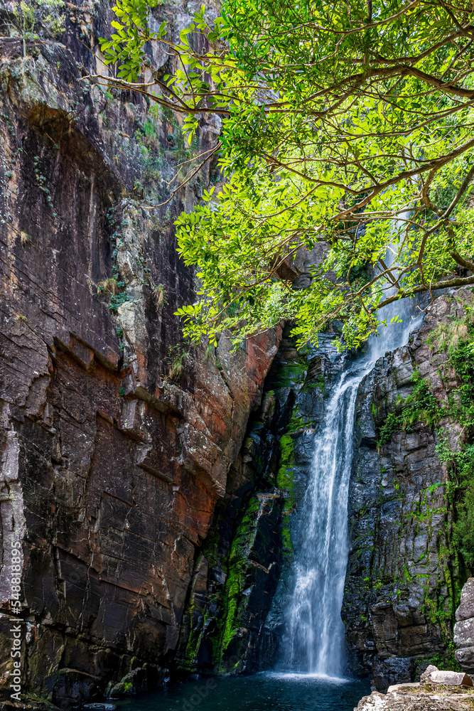 Waterfall between rocks with moss and preserved vegetation in Serra do Cipo in Minas Gerias Waterfall between rocks with moss and preserved vegetation in Serra do Cipo in Minas Gerias
