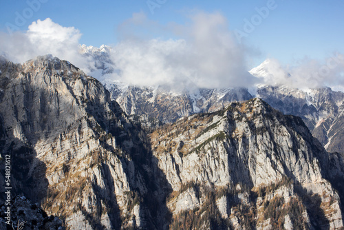 Julian Alps Slovenia, peak Debela Pec 2014 m, winter hiking in Triglav with snowy peaks and mist  photo