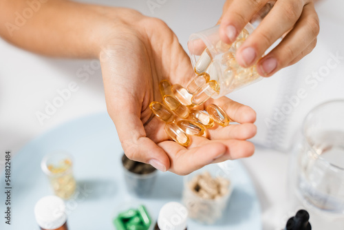 Картината върху платно BADS Capsules of Omega-3 biologically active dietary supplements in hands close-up