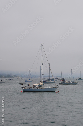 Sailboats standing in front of the coast of Santa Barbara, California, near Stearns Wharf.