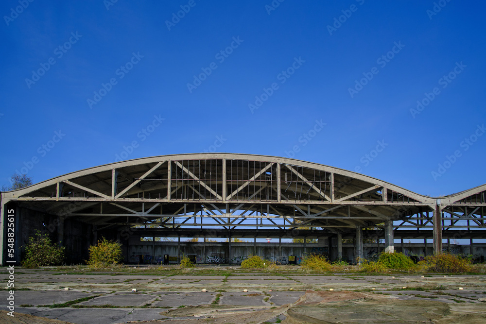 Obraz premium Metal structures German air hangars, abandoned military airfield Notif on Baltic spit.