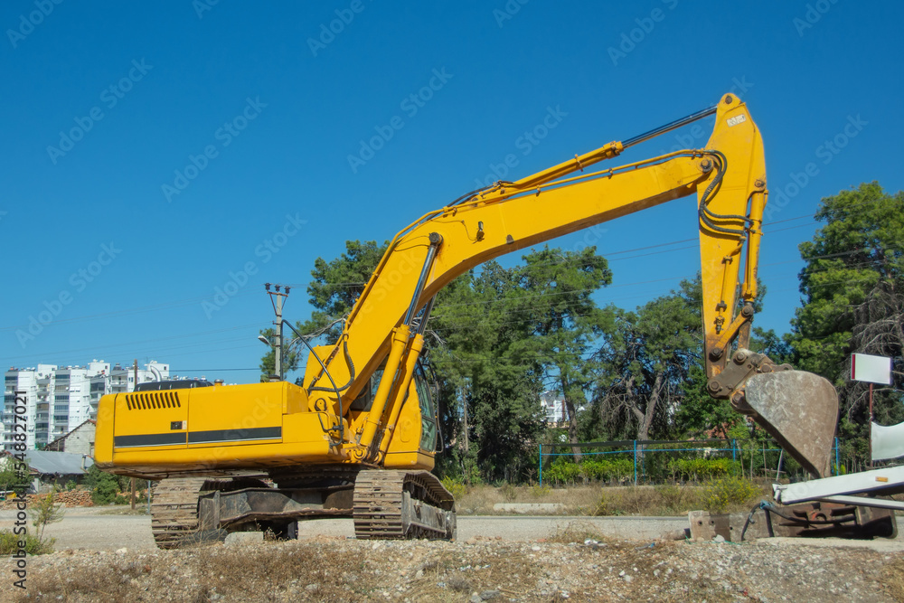 Crawler excavator, side view digs in a trench. Crawler excavator, side view digs in a trench.